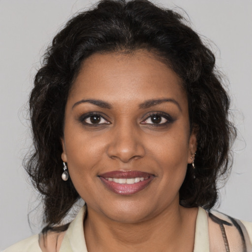 Joyful black young-adult female with medium  brown hair and brown eyes