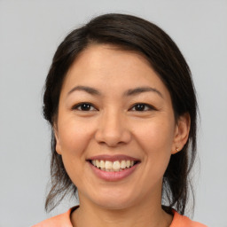 Joyful asian young-adult female with medium  brown hair and brown eyes