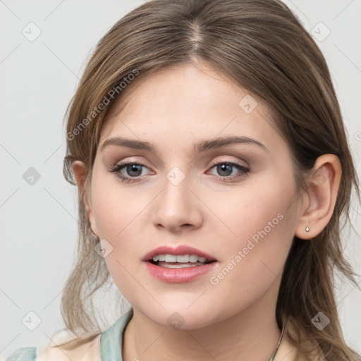 Joyful white young-adult female with long  brown hair and blue eyes