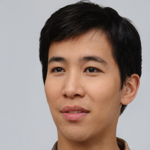 Joyful asian young-adult male with short  black hair and brown eyes