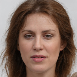 Joyful white adult female with long  brown hair and grey eyes