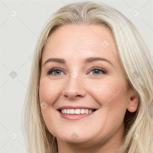 Joyful white young-adult female with long  brown hair and blue eyes