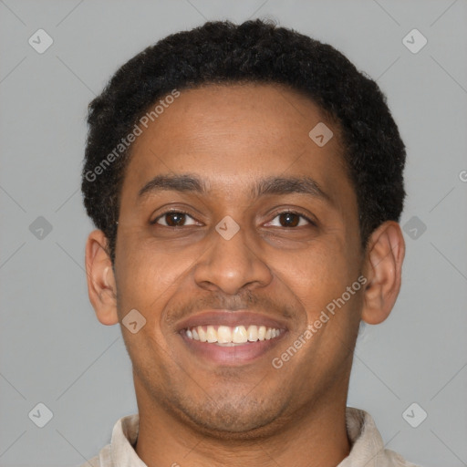 Joyful latino young-adult male with short  brown hair and brown eyes