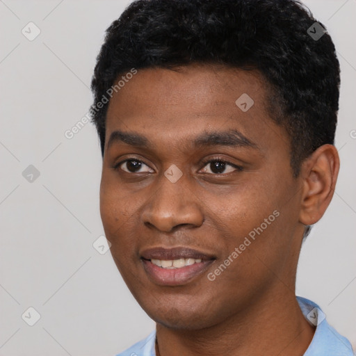 Joyful black young-adult male with short  black hair and brown eyes