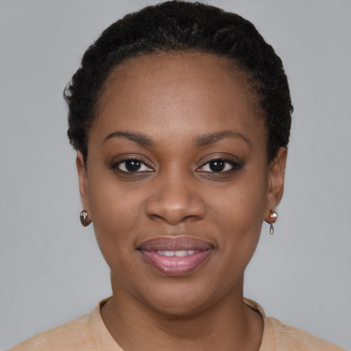 Joyful black young-adult female with short  brown hair and brown eyes