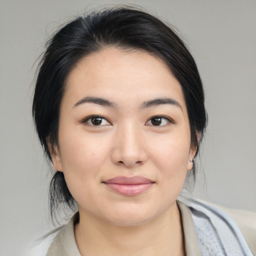 Joyful asian young-adult female with medium  black hair and brown eyes