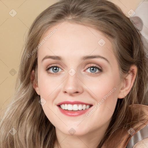 Joyful white young-adult female with long  brown hair and blue eyes