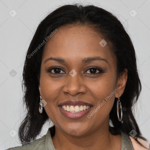 Joyful black young-adult female with long  brown hair and brown eyes