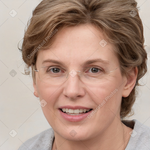 Joyful white adult female with medium  brown hair and blue eyes