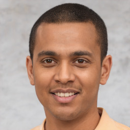 Joyful latino young-adult male with short  black hair and brown eyes