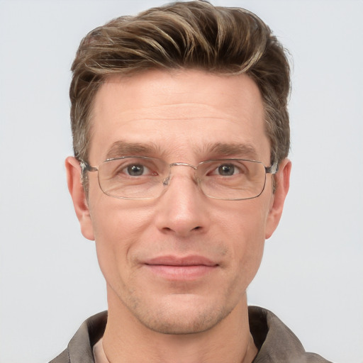 Joyful white adult male with short  brown hair and grey eyes