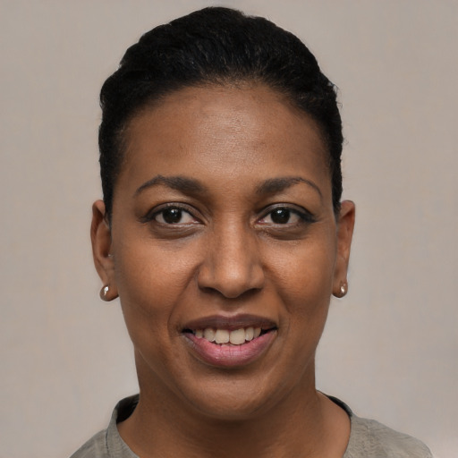 Joyful black young-adult female with short  black hair and brown eyes