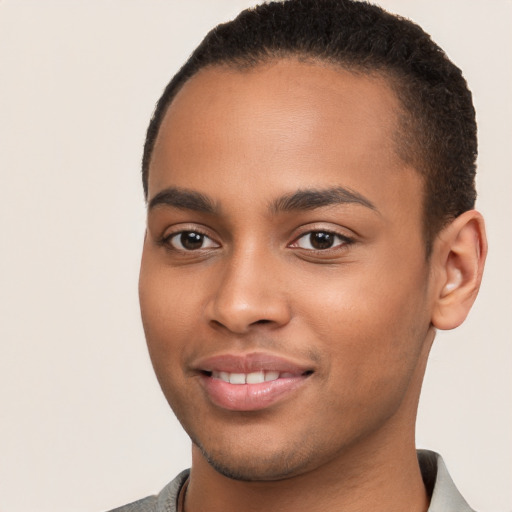 Joyful black young-adult male with short  brown hair and brown eyes