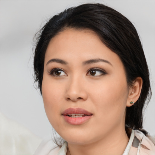 Joyful asian young-adult female with medium  black hair and brown eyes