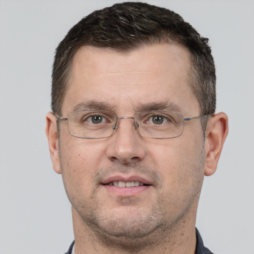 Joyful white adult male with short  brown hair and brown eyes