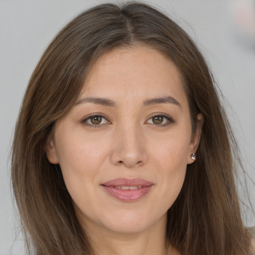 Joyful white young-adult female with long  brown hair and brown eyes