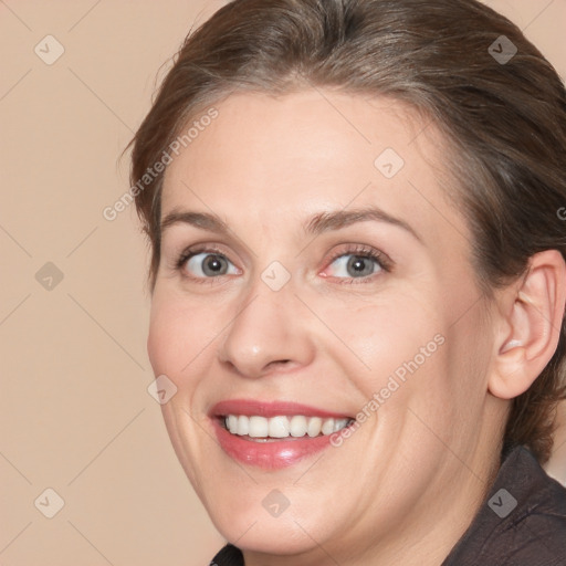 Joyful white adult female with medium  brown hair and brown eyes