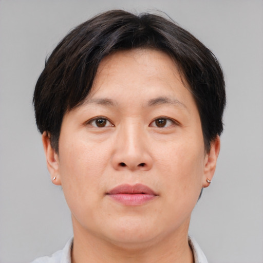 Joyful asian adult female with short  brown hair and brown eyes