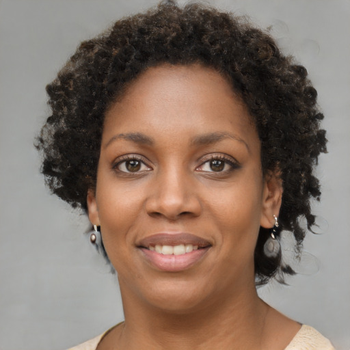 Joyful black young-adult female with short  brown hair and brown eyes