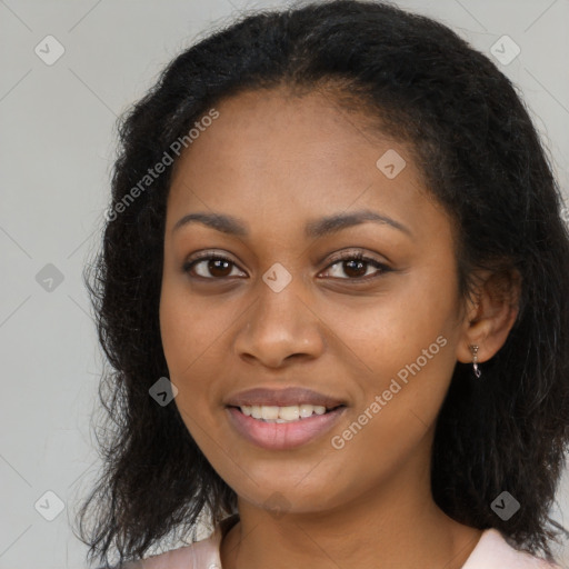 Joyful black young-adult female with long  brown hair and brown eyes