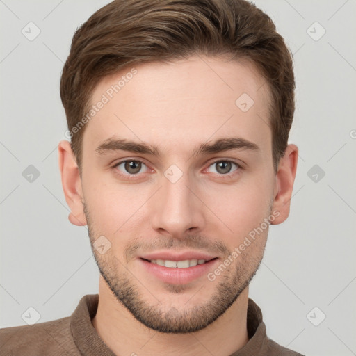 Joyful white young-adult male with short  brown hair and grey eyes