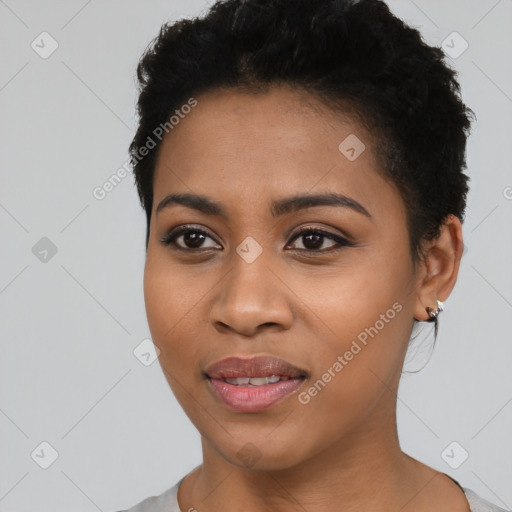 Joyful black young-adult female with short  black hair and brown eyes