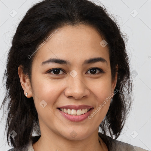 Joyful latino young-adult female with medium  brown hair and brown eyes