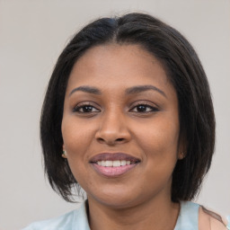 Joyful black young-adult female with medium  brown hair and brown eyes