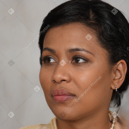 Joyful black young-adult female with medium  black hair and brown eyes