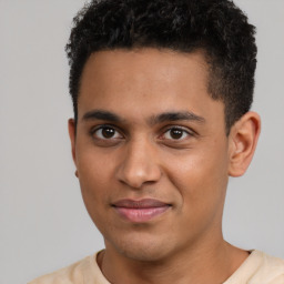 Joyful latino young-adult male with short  brown hair and brown eyes