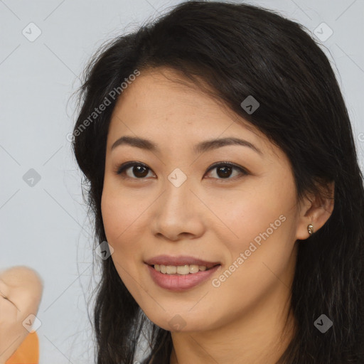 Joyful latino young-adult female with long  brown hair and brown eyes