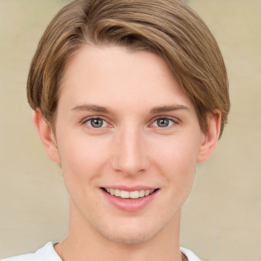 Joyful white young-adult female with short  brown hair and green eyes