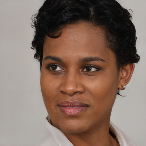 Joyful black young-adult female with short  brown hair and brown eyes
