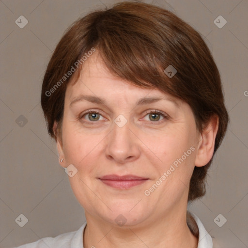 Joyful white adult female with medium  brown hair and grey eyes