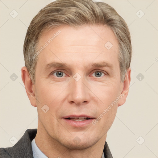 Joyful white adult male with short  brown hair and grey eyes