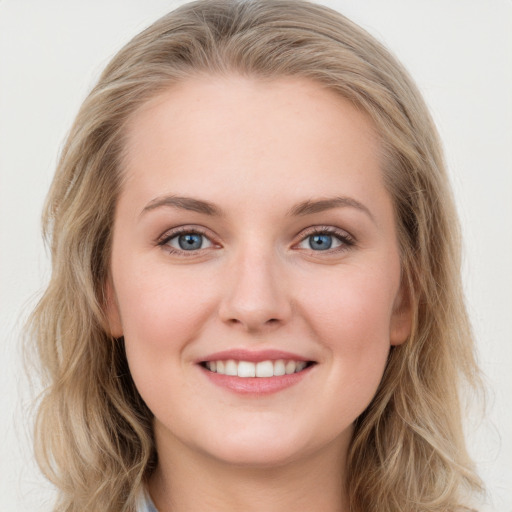 Joyful white young-adult female with long  brown hair and blue eyes