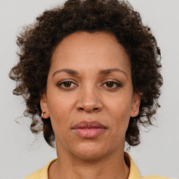 Joyful black adult female with short  brown hair and brown eyes