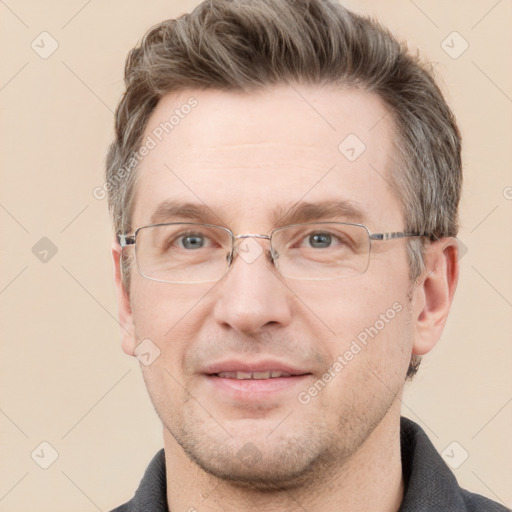 Joyful white adult male with short  brown hair and grey eyes