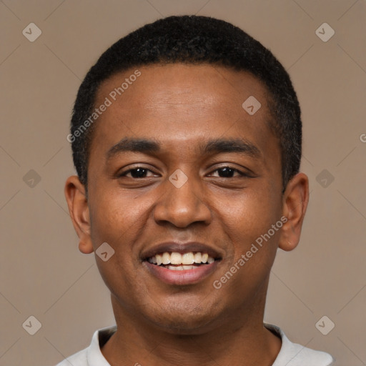 Joyful black young-adult male with short  black hair and brown eyes