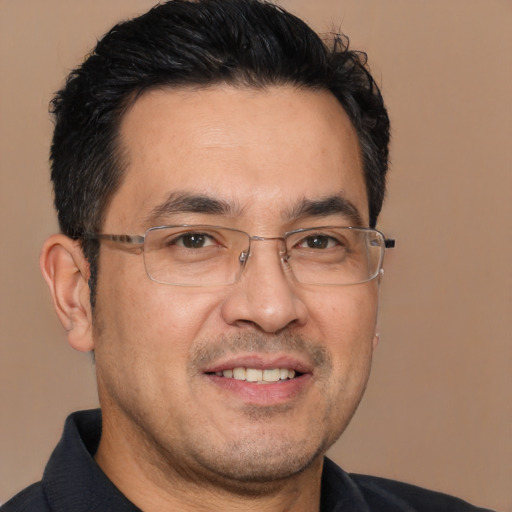 Joyful white adult male with short  black hair and brown eyes