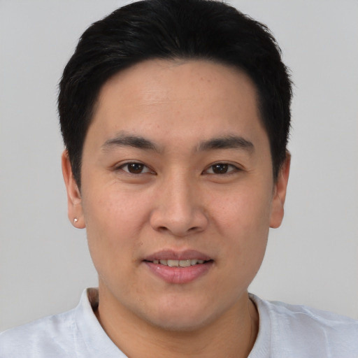 Joyful asian young-adult male with short  black hair and brown eyes