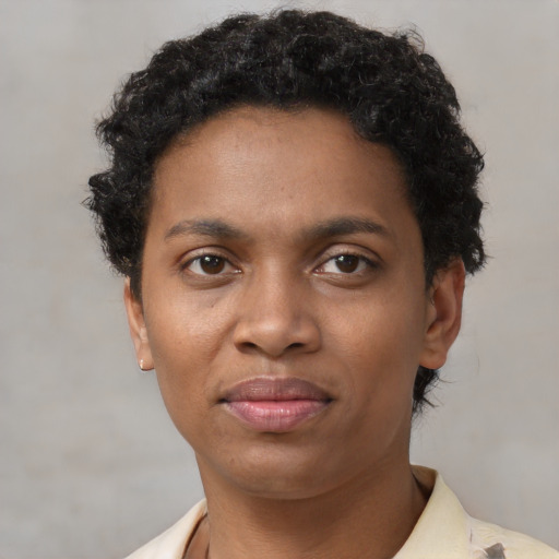 Joyful black young-adult female with short  brown hair and brown eyes