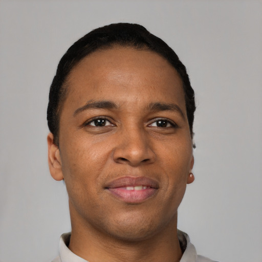 Joyful black young-adult male with short  black hair and brown eyes