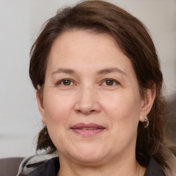 Joyful white adult female with medium  brown hair and grey eyes