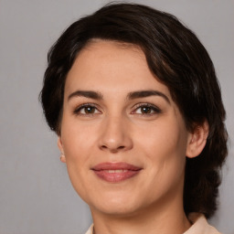 Joyful white adult female with medium  brown hair and brown eyes