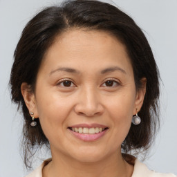 Joyful white adult female with medium  brown hair and brown eyes