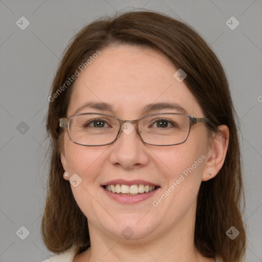 Joyful white adult female with medium  brown hair and grey eyes