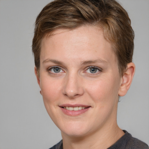 Joyful white young-adult female with short  brown hair and grey eyes