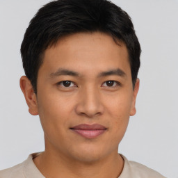 Joyful asian young-adult male with short  brown hair and brown eyes