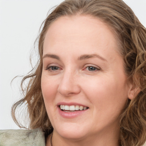 Joyful white young-adult female with medium  brown hair and blue eyes